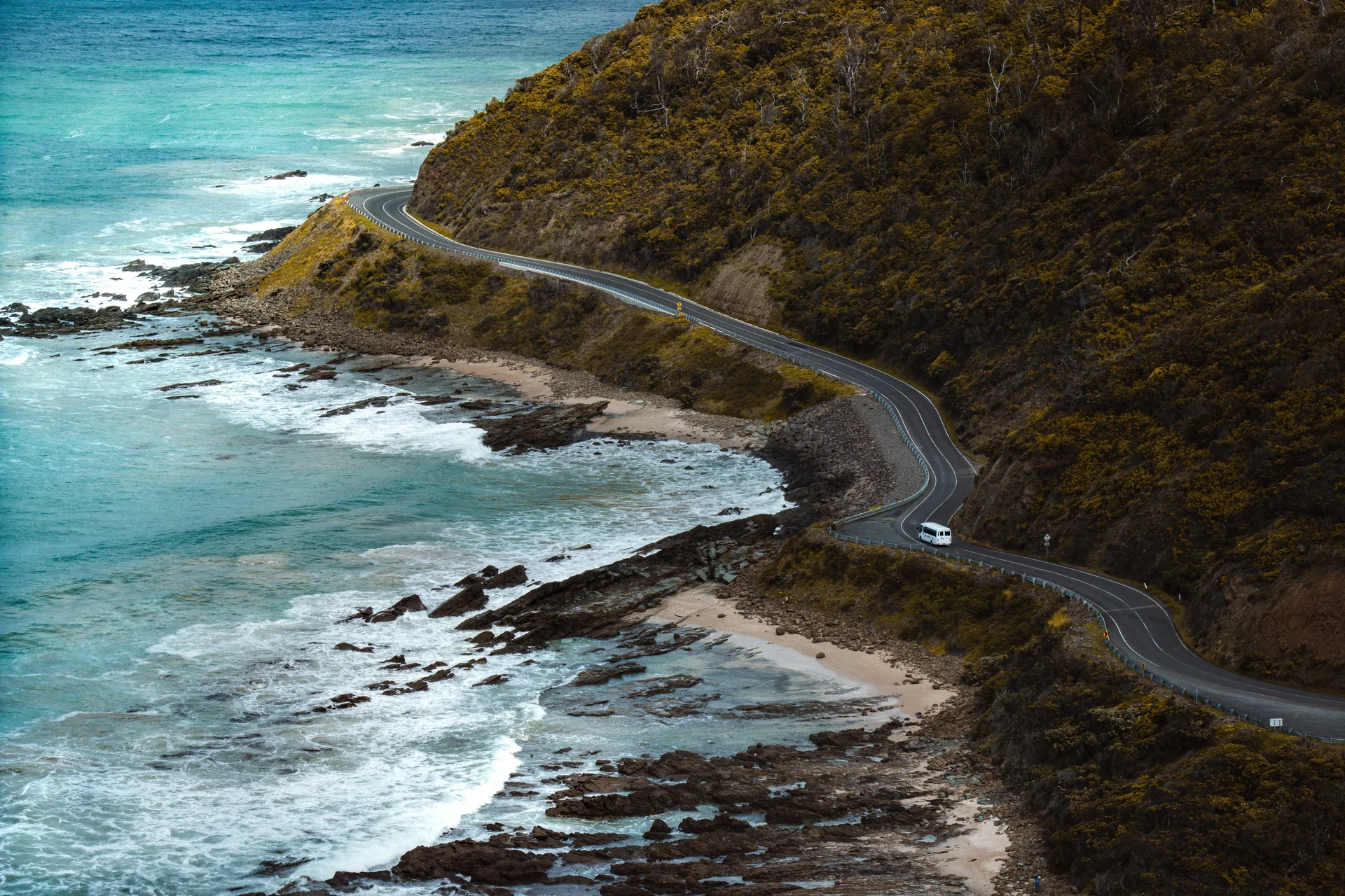 A winding coastal road beside the ocean at Lorne, Victoria, photographed by Ashok Sharma.